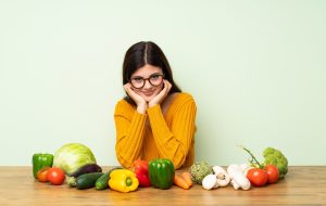 Girl near useful vegetables